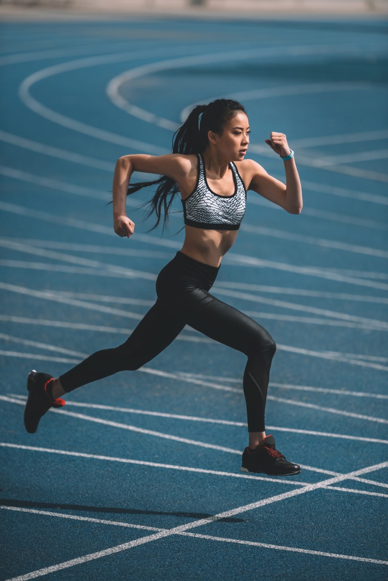 asian sportswoman training on running track stadium young girl running concept